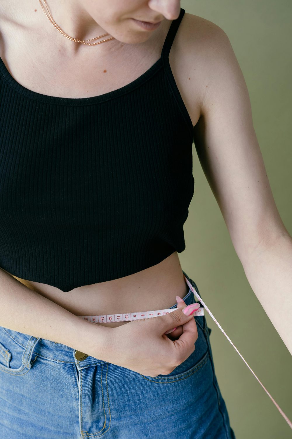 Person measuring their waist